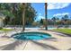 Relaxing hot tub and community pool with chairs and tables at 366 Pinehurst Ln. # 13E, Pawleys Island, SC 29585