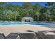 Beautiful community pool area with lounge chairs and lush greenery at 366 Pinehurst Ln. # 13E, Pawleys Island, SC 29585
