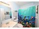 Bright bathroom with a sink, toilet, and vibrant marine-themed shower curtain at 4150 Horseshoe Rd. N # 8, Little River, SC 29566