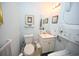 Compact bathroom with sink, toilet, and a stacked washer/dryer unit at 4150 Horseshoe Rd. N # 8, Little River, SC 29566