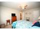 This bedroom includes a ceiling fan, dresser, side tables and a doorway to another room at 4150 Horseshoe Rd. N # 8, Little River, SC 29566