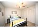 Bright bedroom with ceiling fan, bedside tables, and beach themed decor at 4150 Horseshoe Rd. N # 8, Little River, SC 29566