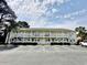 Two-story building with white trim, ample parking, and well-kept landscaping at 4150 Horseshoe Rd. N # 8, Little River, SC 29566
