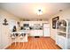 Charming kitchen with white cabinetry, updated appliances, breakfast bar, and modern flooring at 4150 Horseshoe Rd. N # 8, Little River, SC 29566