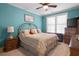 Comfortable bedroom featuring blue walls, a ceiling fan, and a window letting in natural light at 4228 Ravenwood Dr., Little River, SC 29566