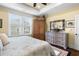 Bright bedroom with large window, wooden armoire, and decorative dresser at 4228 Ravenwood Dr., Little River, SC 29566