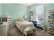 Bright bedroom with neutral carpet, large window, and furnishings with colorful accents at 4228 Ravenwood Dr., Little River, SC 29566