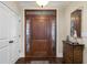 Elegant entry with a decorative wood door and sidelights, enhanced by a beautiful transom window at 4228 Ravenwood Dr., Little River, SC 29566
