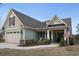 Charming home featuring a two-car garage, well-manicured lawn, and inviting front porch at 4228 Ravenwood Dr., Little River, SC 29566