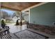 Inviting front porch with outdoor seating and stone accents at 4228 Ravenwood Dr., Little River, SC 29566