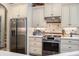 Modern kitchen boasts stainless appliances, tile backsplash, and ample counter space for meal prep at 4228 Ravenwood Dr., Little River, SC 29566
