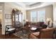 Comfortable living room with a large window, a curio cabinet, and stylish furnishings at 4228 Ravenwood Dr., Little River, SC 29566