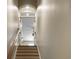 Carpeted staircase with wood railing leading to the upper level of the home at 4228 Ravenwood Dr., Little River, SC 29566