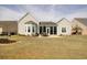 Expansive backyard with lush green grass, patio, and a view of the home's exterior at 432 Highfield Loop, Myrtle Beach, SC 29579