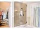 Bathroom with tile floors, glass shower with seat and a view into a walk-in closet at 432 Highfield Loop, Myrtle Beach, SC 29579