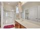 Bathroom featuring a shower with a glass enclosure, white stone walls, and a built-in bench at 432 Highfield Loop, Myrtle Beach, SC 29579