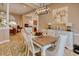Open-concept dining area with a rustic table, open to the living room and kitchen at 432 Highfield Loop, Myrtle Beach, SC 29579