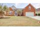 Charming red brick home with a well-manicured lawn and mature palm trees enhancing curb appeal at 432 Highfield Loop, Myrtle Beach, SC 29579