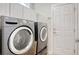 Laundry room with front loading washer and dryer and white storage cabinets at 432 Highfield Loop, Myrtle Beach, SC 29579