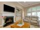 Comfortable living room with fireplace, television, display cabinet and sliding glass doors at 432 Highfield Loop, Myrtle Beach, SC 29579