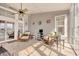 Bright sunroom featuring tile flooring and comfortable wicker seating with a ceiling fan at 432 Highfield Loop, Myrtle Beach, SC 29579