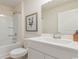 Well-lit bathroom featuring a shower-tub combo, white vanity, framed wall art, and an expansive mirror at 4476 East Coast Ln., Shallotte, NC 28470