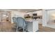 Open-concept kitchen with island seating, stainless steel appliances, and seamless flow to the adjacent living spaces at 4476 East Coast Ln., Shallotte, NC 28470