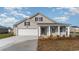 Charming single-story home featuring a manicured lawn, attached garage, and covered porch at 4480 East Coast Ln., Shallotte, NC 28470