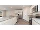 Open kitchen view features stainless steel appliances, granite counters, island sink and gray wood floors at 4480 East Coast Ln., Shallotte, NC 28470