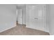 Bedroom featuring neutral carpet and gray walls, closet, and open door at 48 Cape Point Dr., Conway, SC 29527