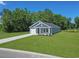 Landscaped home with gray siding, a well-manicured lawn, and an adjacent pond at 48 Cape Point Dr., Conway, SC 29527