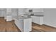Kitchen island with white cabinets, gray countertops, and stainless steel appliances at 48 Cape Point Dr., Conway, SC 29527