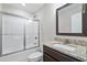 Bathroom with a granite countertop vanity, mirror, and a bathtub with sliding glass doors at 480 Oakham Dr., Conway, SC 29527