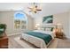 Staged primary bedroom featuring a large window for natural light, a ceiling fan, and soft carpet at 480 Oakham Dr., Conway, SC 29527