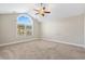 A light-filled, unfurnished bedroom featuring a large window, carpet, and ceiling fan at 480 Oakham Dr., Conway, SC 29527
