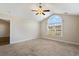 An unfurnished room with a large window, carpet flooring, and ceiling fan at 480 Oakham Dr., Conway, SC 29527