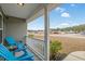 Inviting front porch with blue chairs and neighborhood views in a quiet residential community on a clear, sunny day at 480 Oakham Dr., Conway, SC 29527