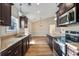 A lovely kitchen with dark cabinets, granite countertops, stainless appliances, and bright natural light at 480 Oakham Dr., Conway, SC 29527
