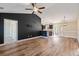 Open-concept living room with wood floors, a painted accent wall, and seamlessly connecting to the kitchen at 480 Oakham Dr., Conway, SC 29527