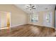 Open living space boasts sleek flooring and ample natural light coming through a large window by the front door at 480 Oakham Dr., Conway, SC 29527