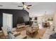 Virtually staged living room with sofas, wooden floors, and a view of kitchen with island at 480 Oakham Dr., Conway, SC 29527