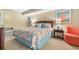 Bedroom featuring seaside theme and decorative pillows, end tables with lamps, and comfy chair at 501 S Ocean Blvd. # 1006, North Myrtle Beach, SC 29582