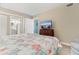 Bedroom featuring seaside theme linens, dresser with TV, and two entry doorways at 501 S Ocean Blvd. # 1006, North Myrtle Beach, SC 29582