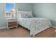 Well-lit bedroom features a comfortable bed, nautical themed linens, and a decorative bedside table at 501 S Ocean Blvd. # 1006, North Myrtle Beach, SC 29582