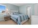 Bright bedroom with coastal decor, bedside table, and window with blinds at 501 S Ocean Blvd. # 1006, North Myrtle Beach, SC 29582