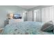 Bright bedroom featuring nautical themed bedspread, dresser with TV, and two entry doorways at 501 S Ocean Blvd. # 1006, North Myrtle Beach, SC 29582