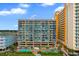 The Verandas condo building featuring a beautiful pool area with tropical landscaping, creating a resort-style atmosphere at 501 S Ocean Blvd. # 1006, North Myrtle Beach, SC 29582