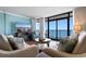 Cozy living room featuring comfortable seating, ocean views, and a large screen TV at 501 S Ocean Blvd. # 1006, North Myrtle Beach, SC 29582