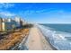 An aerial view of a vast sandy beach and oceanfront, highlighting the beautiful coastline and beachfront community at 5200 N Ocean Blvd. # 957, Myrtle Beach, SC 29577