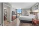 Bedroom featuring wood floors, large windows, and connected bathroom at 5200 N Ocean Blvd. # 957, Myrtle Beach, SC 29577